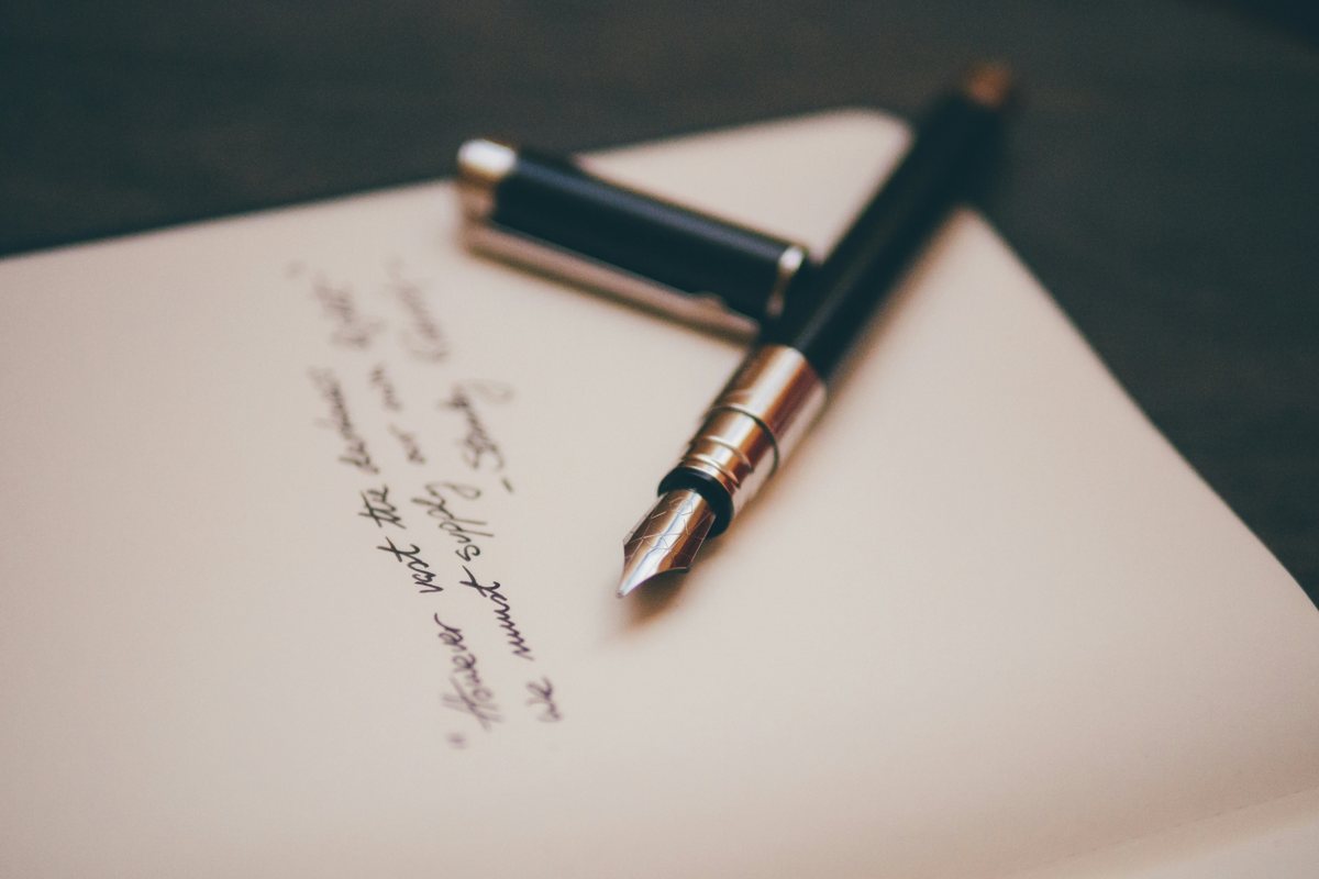 Fountain pen resting on a handwritten document